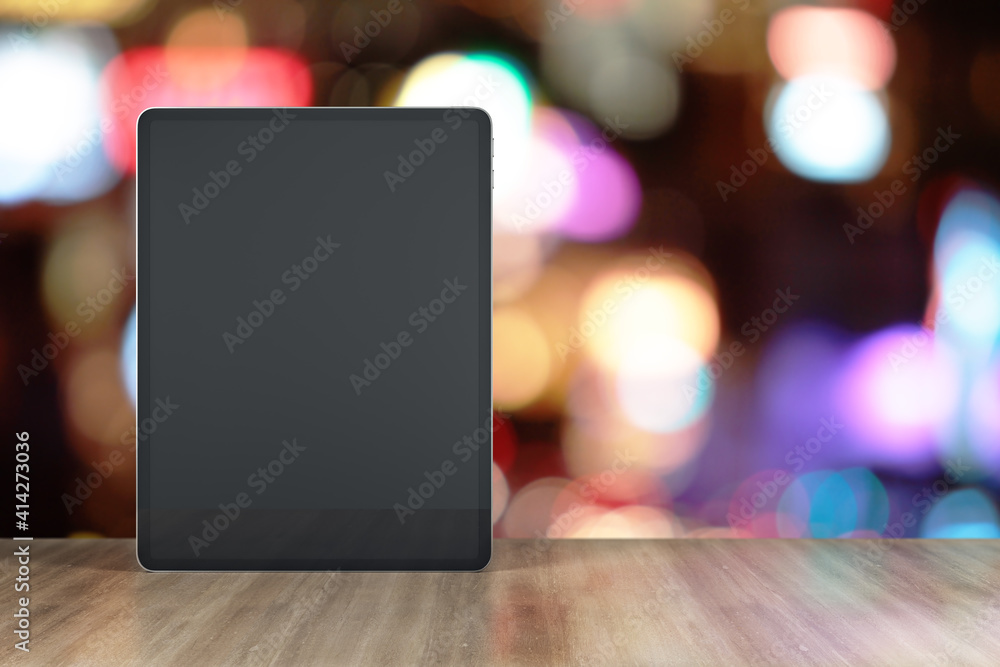 Blank black digital tablet display with place for your sign on wooden table at blurry background. Mockup Blank black digital tablet display with place for your sign on wooden table at blurry background. Mockup