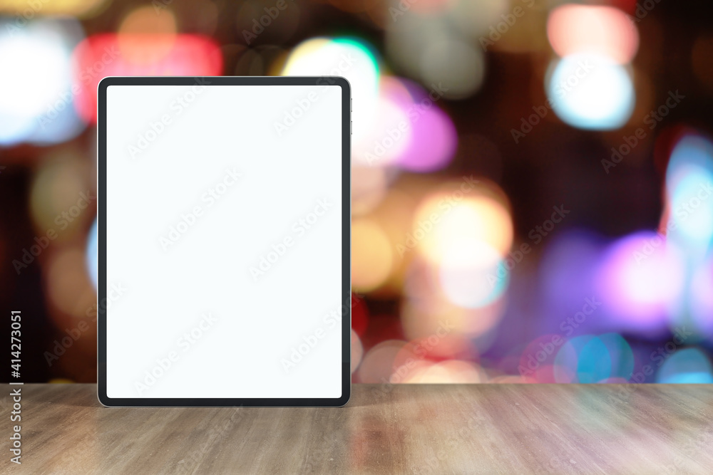 Blank white digital tablet display with place for your sign on wooden table at blurry background. Mockup Blank white digital tablet display with place for your sign on wooden table at blurry background. Mockup
