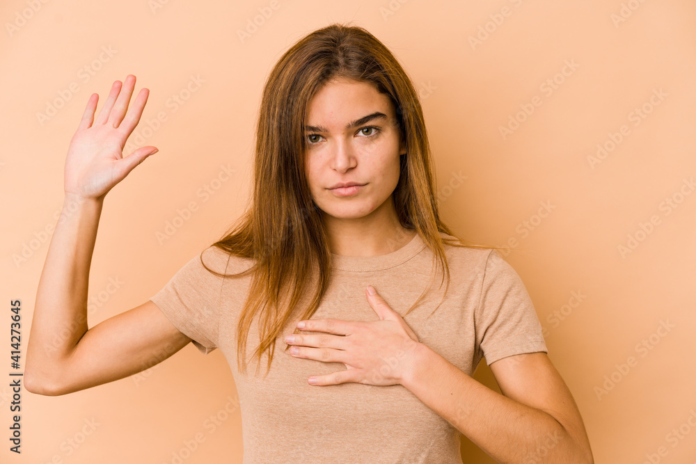 Young skinny caucasian teenager girl taking an oath, putting hand on chest. Young skinny caucasian teenager girl taking an oath, putting hand on chest.