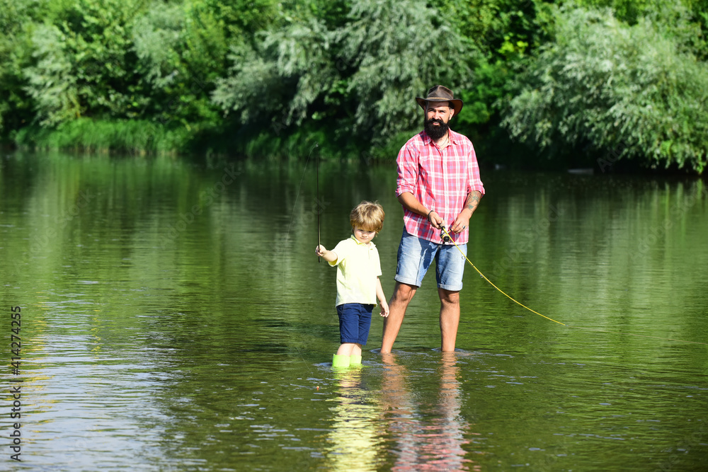 Fathers day. Dad and his child son are fishing on sky background. Fishing became a popular recreational activity. Fathers day. Dad and his child son are fishing on sky background. Fishing became a popular recreational activity.
