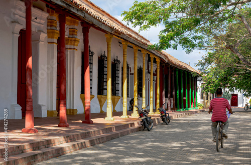 Colonial street with houses with long columns in red, yellow, brown and green colors. photo