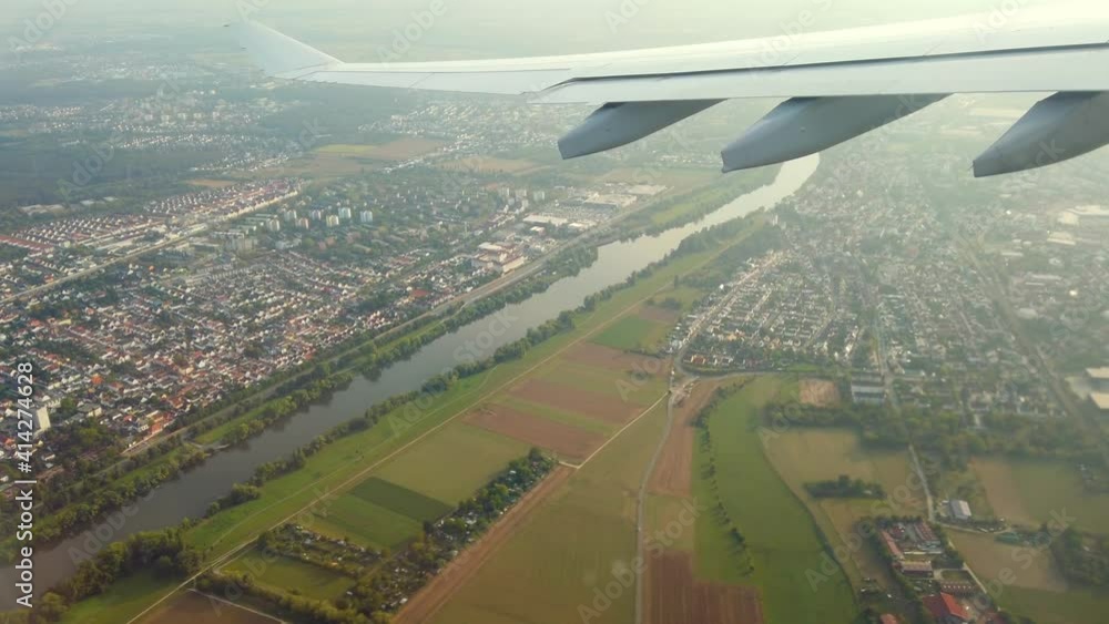 View from a flying airplane, clouds sky and land from above View from a flying airplane, clouds sky and land from above