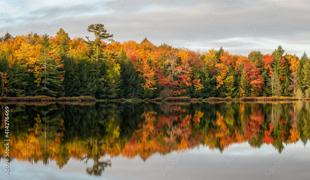Earlier morning autumn reflections on a Michigan lake - Upper Peninsula UP Earlier morning autumn reflections on a Michigan lake - Upper Peninsula UP