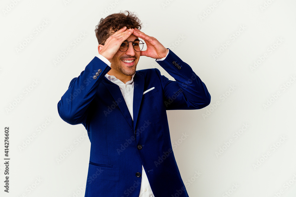 Young business caucasian man isolated on white background laughs joyfully keeping hands on head. Happiness concept. Young business caucasian man isolated on white background laughs joyfully keeping hands on head. Happiness concept.