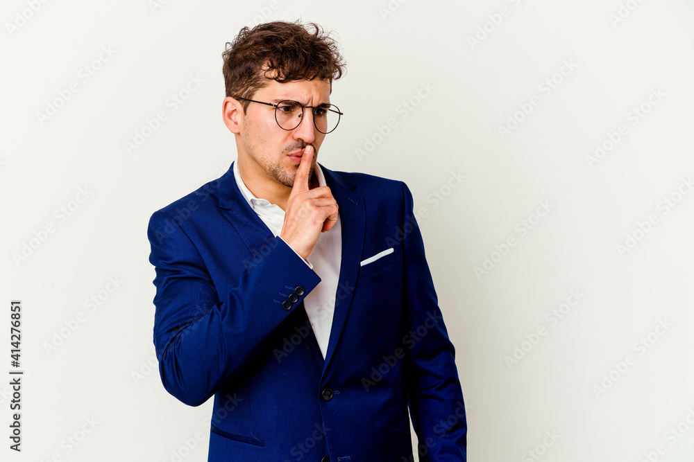 Young business caucasian man isolated on white background keeping a secret or asking for silence.