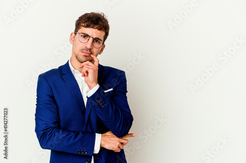 Young business caucasian man isolated on white background looking sideways with doubtful and skeptical expression.