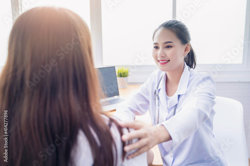 Female doctor comforting caressing taking care of young patients diagnosing symptom to Asian woman patient, medical healthcare worker expert specialist diagnosis, working hospital modern meeting room