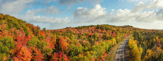 Sunset Autumn drive through the tunnel of Trees in Michigan Upper Peninsula UP - Highway 41  M26 Aerial view