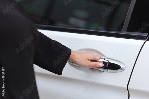 Close up female hand opening car or automobile door © feeling lucky