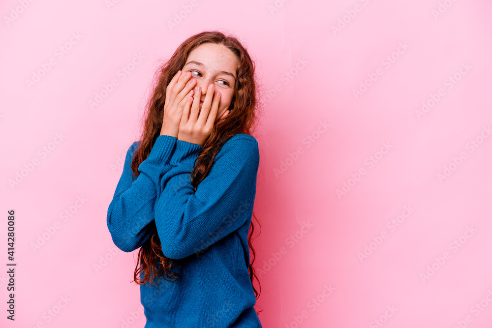 Little caucasian girl isolated on pink background laughing about something, covering mouth with hands. Little caucasian girl isolated on pink background laughing about something, covering mouth with hands.