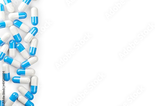 Blue and white pill capsules border edge over white background, medical treatment, pharmaceutical or medication concept