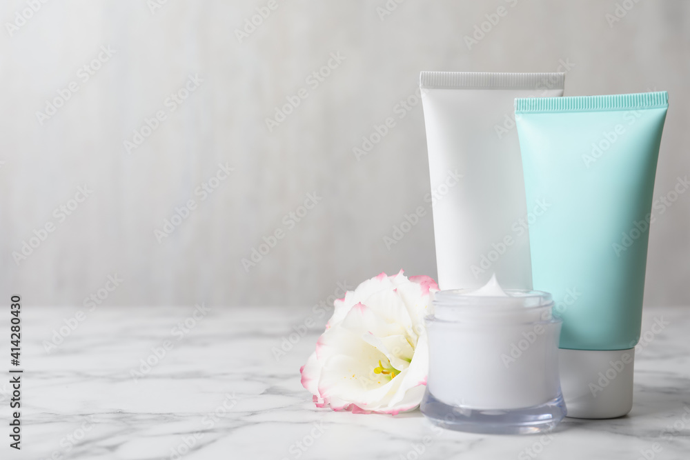 Composition with cosmetic products on white marble table. Space for text Composition with cosmetic products on white marble table. Space for text