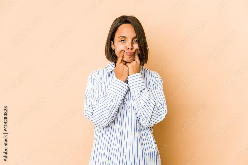 Young hispanic woman isolated doubting between two options. Young hispanic woman isolated doubting between two options.