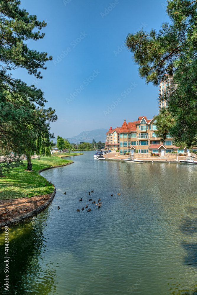 Ducks in front of luxury residential area with boat pier at the entrance