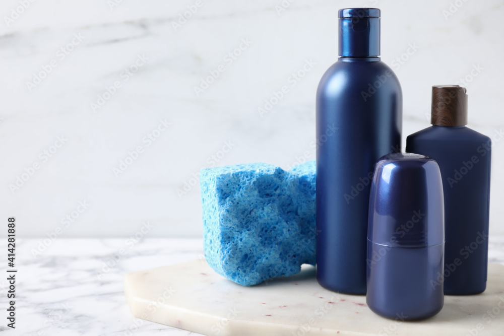 Set of different men's cosmetic products on white marble table. Space for text Set of different men's cosmetic products on white marble table. Space for text