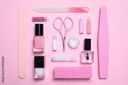 Flat lay composition with nail care products on pink background