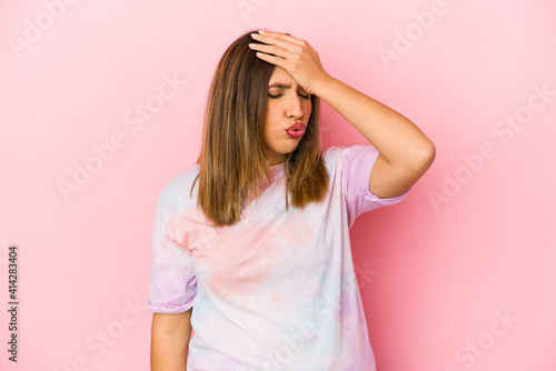 Young indian woman isolated on pink background forgetting something, slapping forehead with palm and closing eyes.