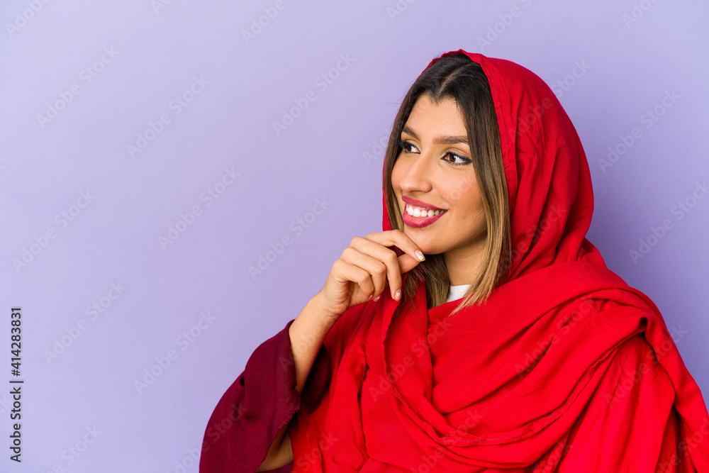 Young indian woman wearing a hijab isolated looking sideways with doubtful and skeptical expression. Young indian woman wearing a hijab isolated looking sideways with doubtful and skeptical expression.