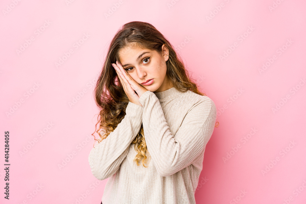 Young caucasian woman yawning showing a tired gesture covering mouth with hand. Young caucasian woman yawning showing a tired gesture covering mouth with hand.