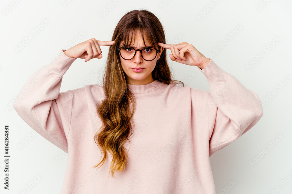 Young caucasian cute woman isolated on white background focused on a task, keeping forefingers pointing head. Young caucasian cute woman isolated on white background focused on a task, keeping forefingers pointing head.