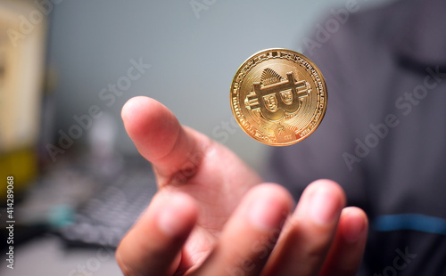 Digital coin Floating over the palm against a blurred background