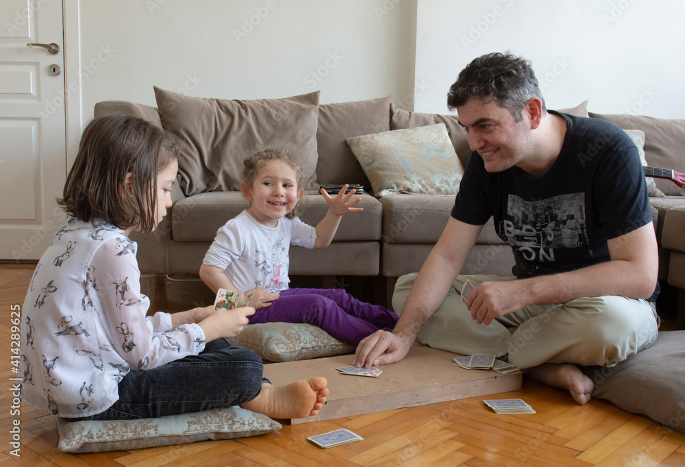dad and kids playing and learning card games. dad and kids playing and learning card games.