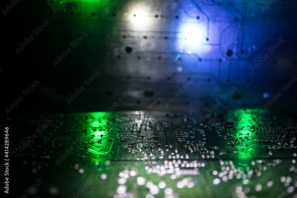 Stylized photo of an electronic microcircuit. Microcircuit, contacts, electronics, motherboard. Black background. Macro photography of electronic devices.