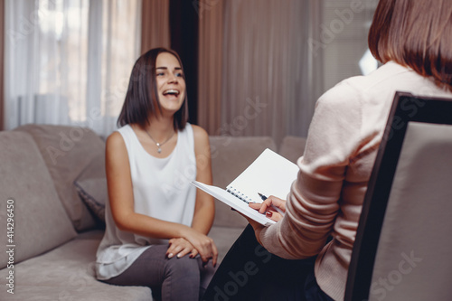 Smiling young patient sitting at a psychologist's appointment and laughing. Psychotherapy and psychocorrection. Consultation concept