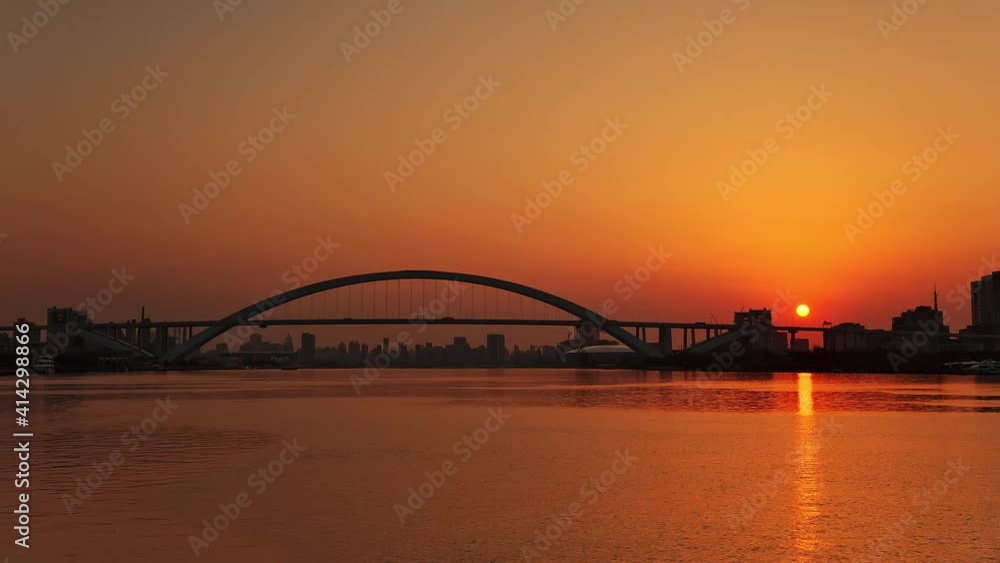Time-lapse of Lupu Bridge and Huangpu River at sunrise, Shanghai in China Time-lapse of Lupu Bridge and Huangpu River at sunrise, Shanghai in China