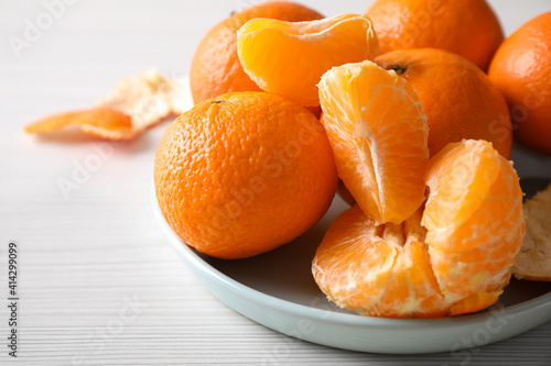 Delicious fresh ripe tangerines on white table, closeup