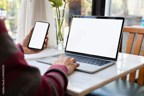 computer screen,cell phone blank mockup.hand woman work using laptop texting mobile.with white background for advertising,contact business search information on desk in cafe.marketing,design © panitan