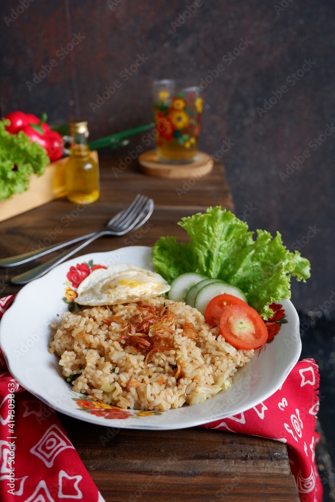 a plate of fried rice with vegetables and fried egg on the table 