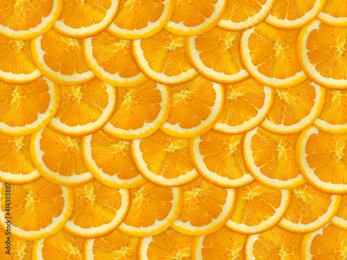 an orange cut into slices is lying on the table. photo