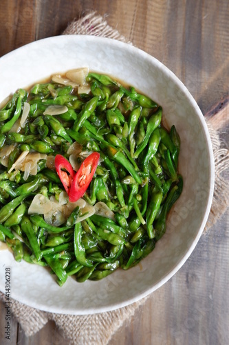 a plate of sauteed limnocharis flower or sawah-lettuce flower on the table   photo