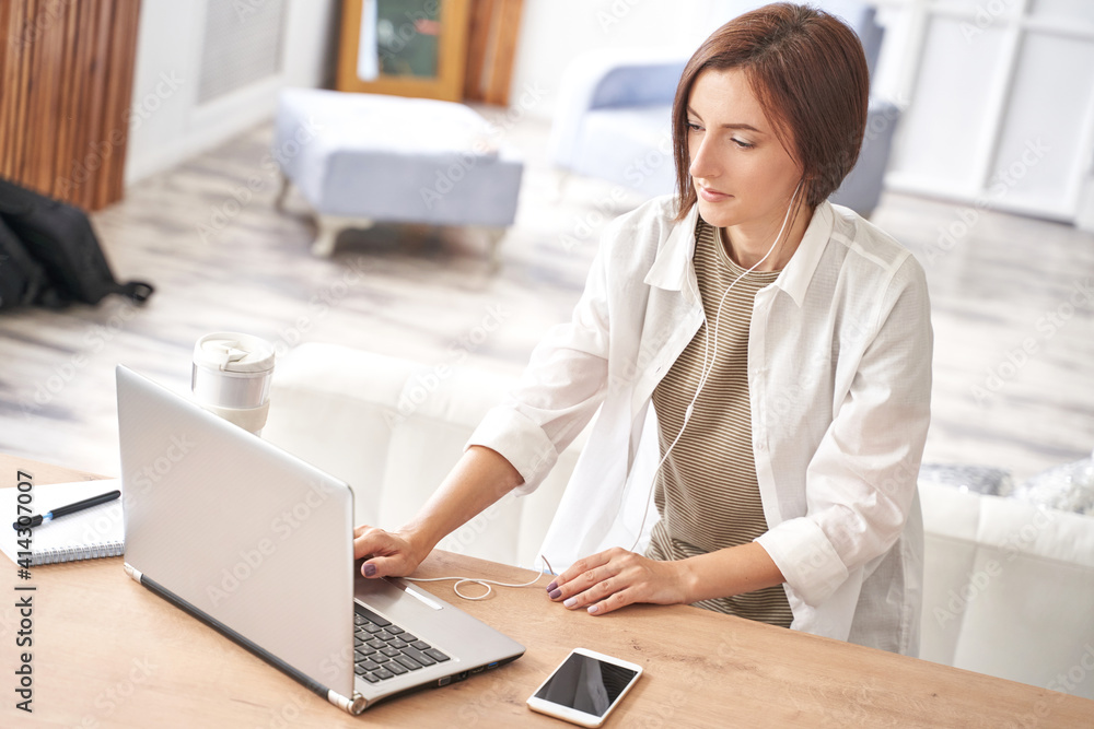 Young woman sitting at home. Working on notebook. Online study concept. Safety lockdown distance teaching. Female person. Quarantine office. Business writer. Young woman sitting at home. Working on notebook. Online study concept. Safety lockdown distance teaching. Female person. Quarantine office. Business writer.