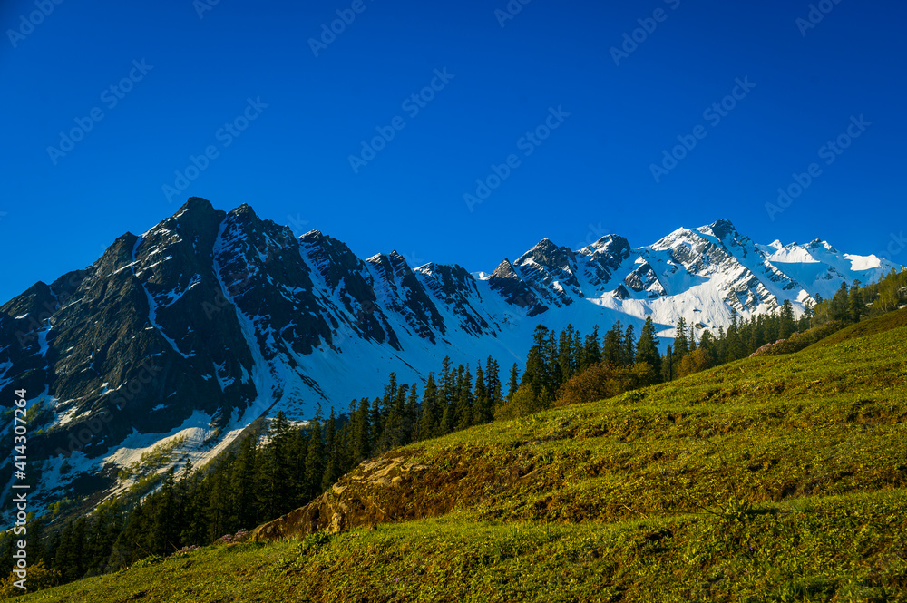 Landscape in summer. View of Majestic Himalayan mountains on the trek to Surpass in Parvati Valley, Himachal Pradesh, India.