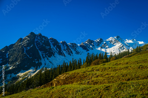 Landscape in summer. View of Majestic Himalayan mountains on the trek to Surpass in Parvati Valley, Himachal Pradesh, India.