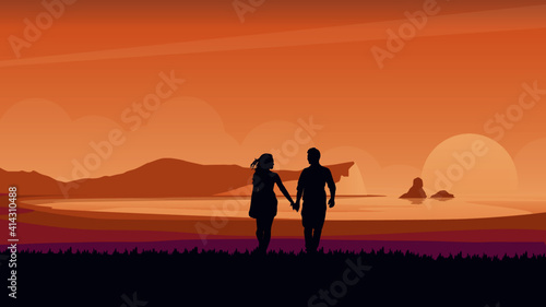 couple walking on the beach at sunset