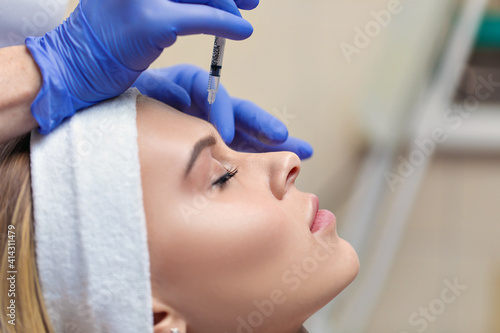 Skin rejuvenation and nourishment procedure. A needle and syringe are used to inject nutrients into the skin. Personal and skin care. Beauty salon concept