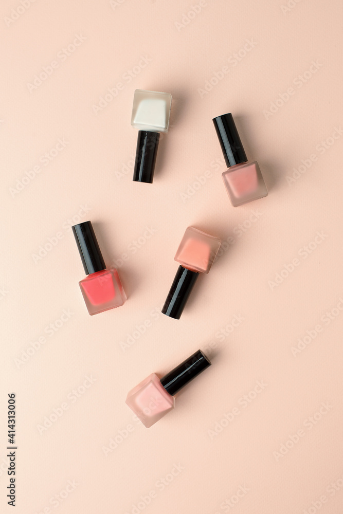 Set of nail polish bottles neutral natural colors on beige background. Concept of pallete for french manicure, woman beauty cosmetology, handcare, beautician industry Set of nail polish bottles neutral natural colors on beige background. Concept of pallete for french manicure, woman beauty cosmetology, handcare, beautician industry