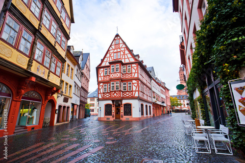 Haus zum Aschaffenberg is famous old town historic street alley in capital city   Crowd of people walking along street.