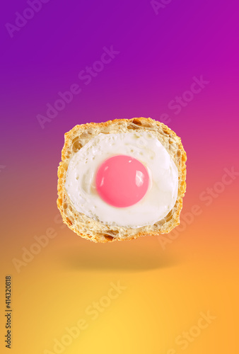 Funny fried eggs on a yellow-pink gradient background. The concept of a good day and mood