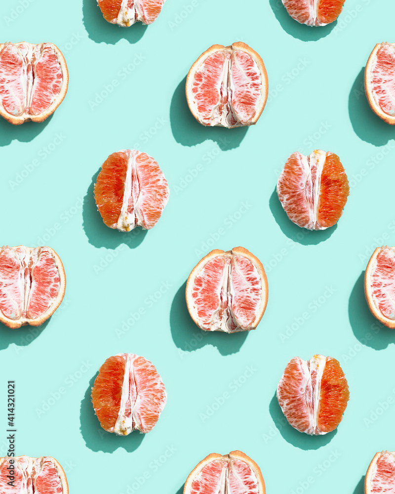 Colorful fruit pattern from fresh red grapefruit half path on turquoise. Minimal flat lay concept. Colorful fruit pattern from fresh red grapefruit half path on turquoise. Minimal flat lay concept.