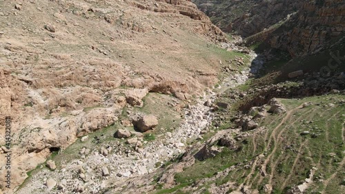 hikers on the trail to the ancient faran monastery near ein prat in wadi qelt in the west bank. High quality 4k footage photo