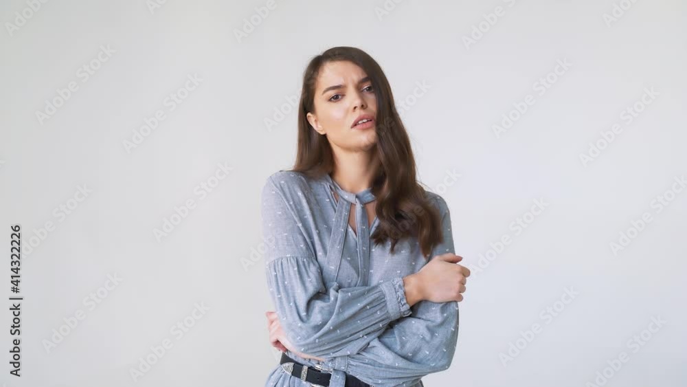 An angry, disgruntled woman. She looks straight ahead, white background An angry, disgruntled woman. She looks straight ahead, white background