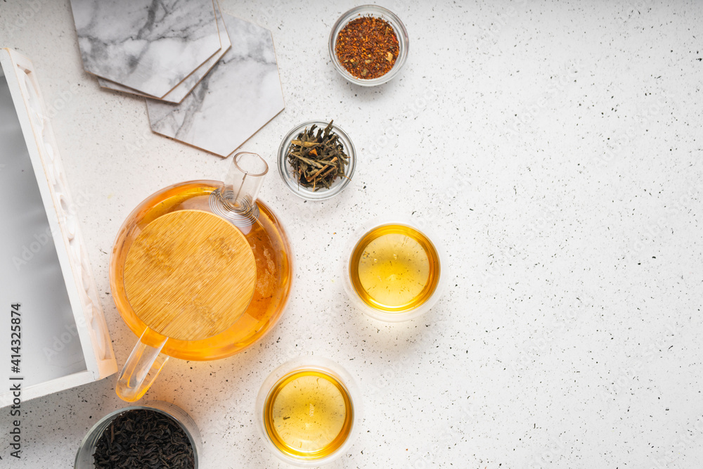 light tea flatley. pour black tea into thermos cups, on a light background. tea ceremony with different types of leaf tea light tea flatley. pour black tea into thermos cups, on a light background. tea ceremony with different types of leaf tea