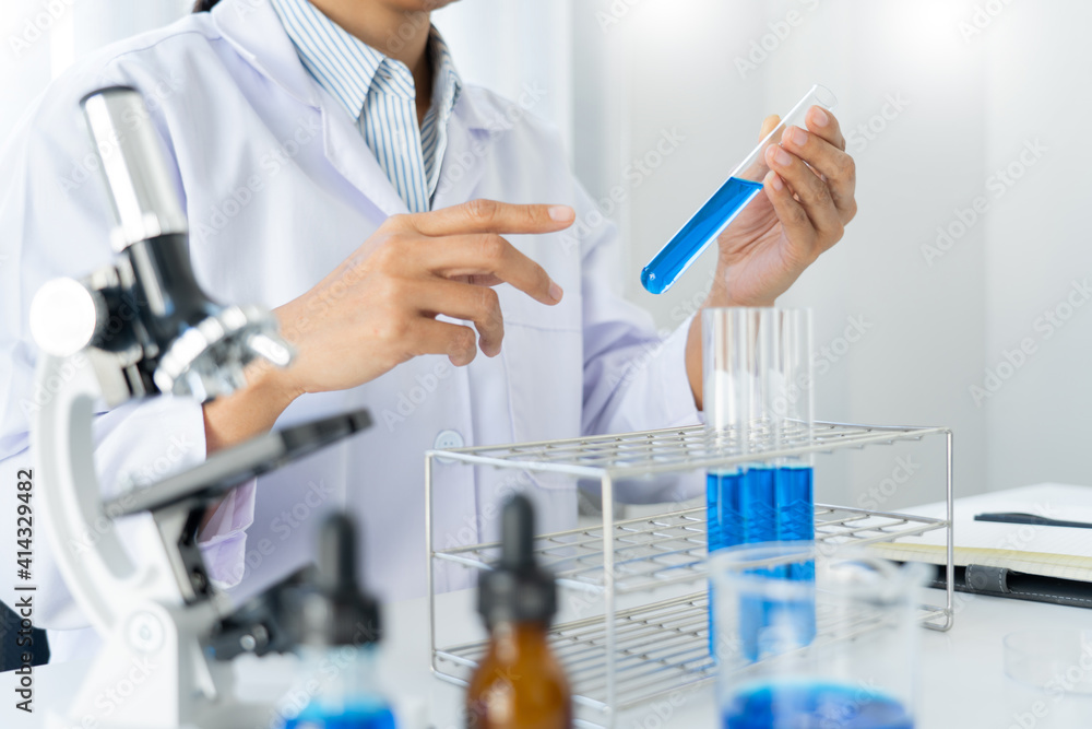 scientists researching in laboratory in white lab coat, gloves analysing, looking at test tubes sample, biotechnology concept scientists researching in laboratory in white lab coat, gloves analysing, looking at test tubes sample, biotechnology concept