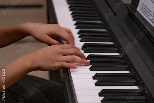 Close-up of a music performer's hand playing the piano. Child learns to play the piano at home