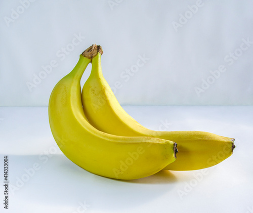 Two ripe bananas on a light background