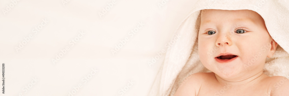 Cute small boy lying at bed. Childhood bath concept. Light background. Smiling child. Happy emotion. Copyspace. Stay home. Towel mockup. Horizontal banner Cute small boy lying at bed. Childhood bath concept. Light background. Smiling child. Happy emotion. Copyspace. Stay home. Towel mockup. Horizontal banner